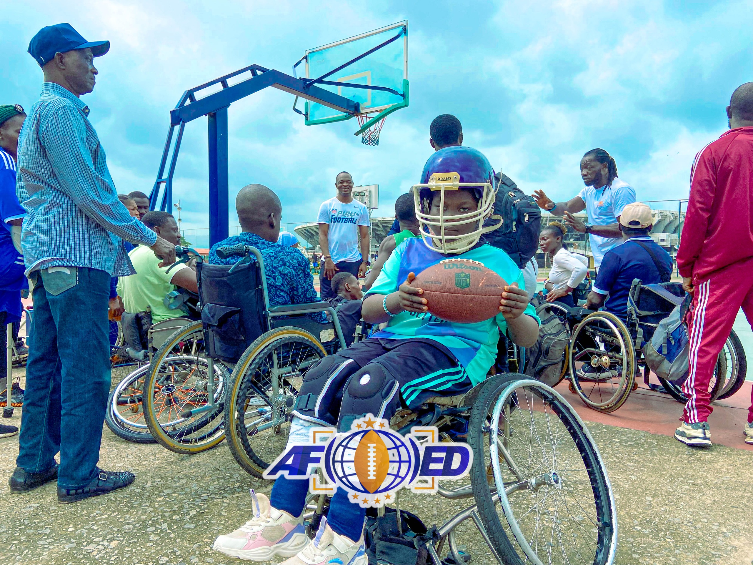 Young wheelchair athlete holding a football